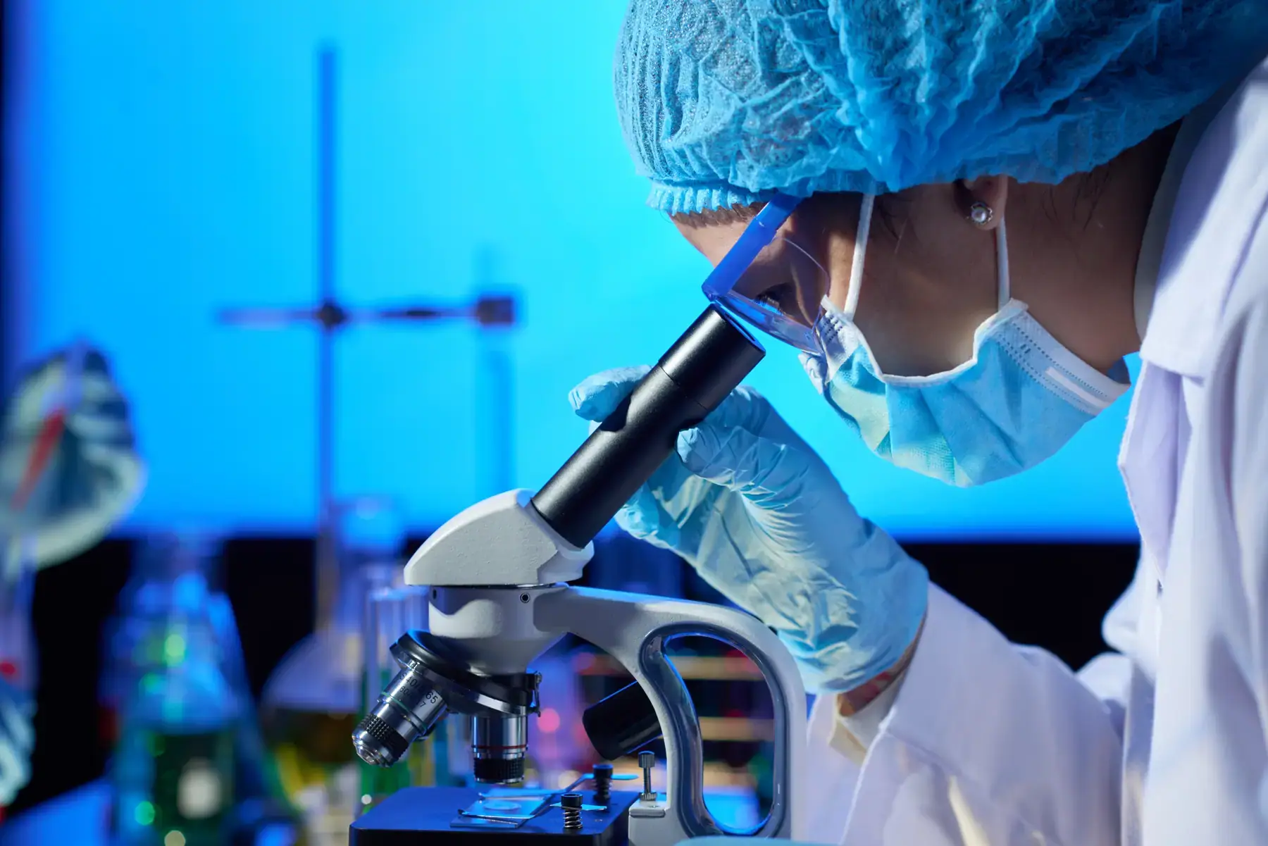 Researcher examining a sample in the Dow Health Research laboratory